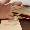Elegant Gold Round Dial Floral Charm Bangle Watch for Women