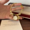 Elegant Gold Round Dial Floral Charm Bangle Watch for Women